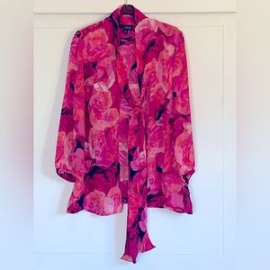 Long sleeve dress blouse.  Long attached neck tie.  Button down front.  Sheer.